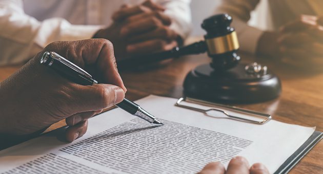 Judge gavel with Justice lawyers deciding, consultation on marriage divorce between married couple and signing divorce documents on table. Concepts of Law and Legal sevices.