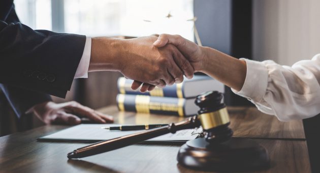 Good service cooperation of Consultation between a male lawyer and business woman customer, Handshake after good deal agreement, Law and Legal concept.