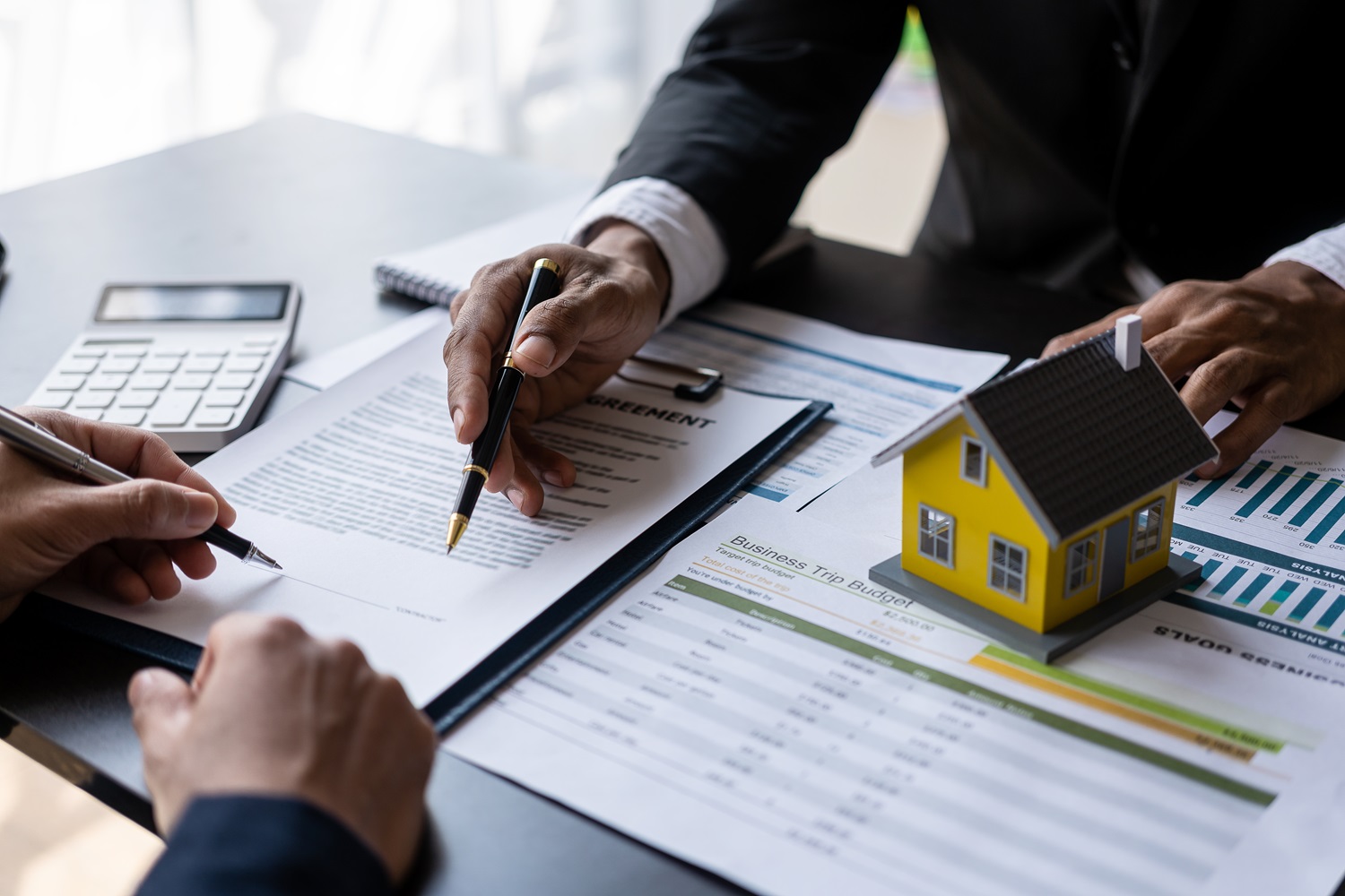 Real,Estate,Agent,Holding,Hands,To,Client,To,Sign,Agreement